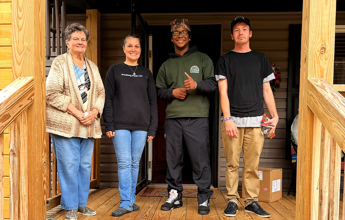 A Carter's Care crew with a customer at her front door in Greenville SC